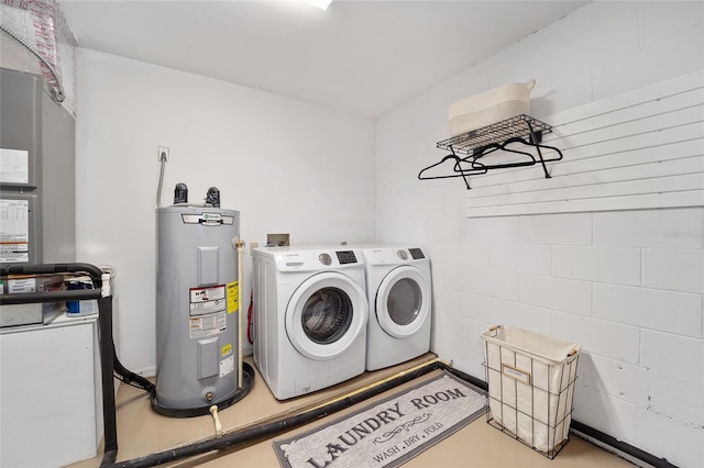 laundry area with washing machine and clothes dryer and electric water heater