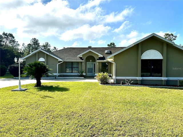 ranch-style home featuring a front yard