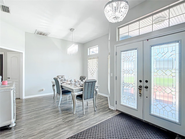 interior space featuring french doors, hardwood / wood-style floors, and a notable chandelier