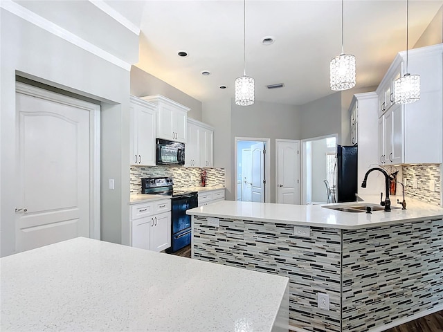 kitchen with white cabinets, pendant lighting, sink, and black appliances