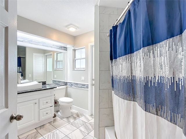 full bathroom with shower / bathtub combination with curtain, vanity, and toilet