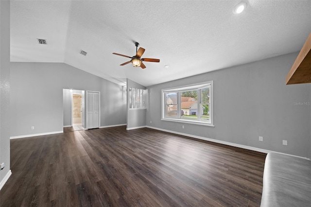 unfurnished living room featuring dark hardwood / wood-style floors, a textured ceiling, vaulted ceiling, and ceiling fan