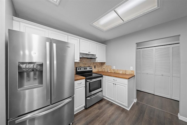 kitchen with white cabinetry, butcher block counters, stainless steel appliances, and dark hardwood / wood-style flooring