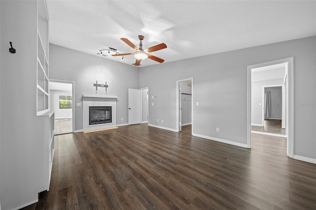 unfurnished living room with dark hardwood / wood-style floors and ceiling fan