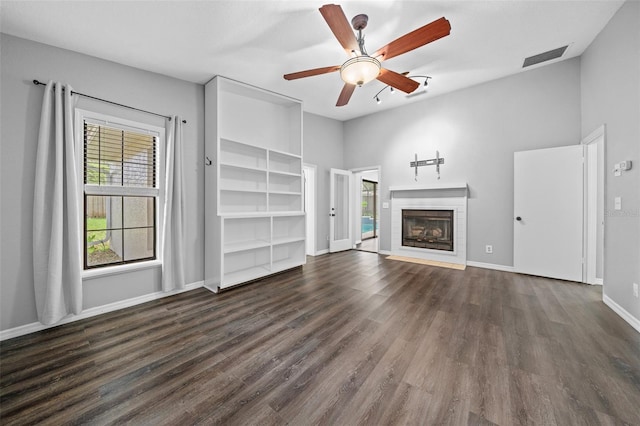 unfurnished living room with ceiling fan and dark hardwood / wood-style floors