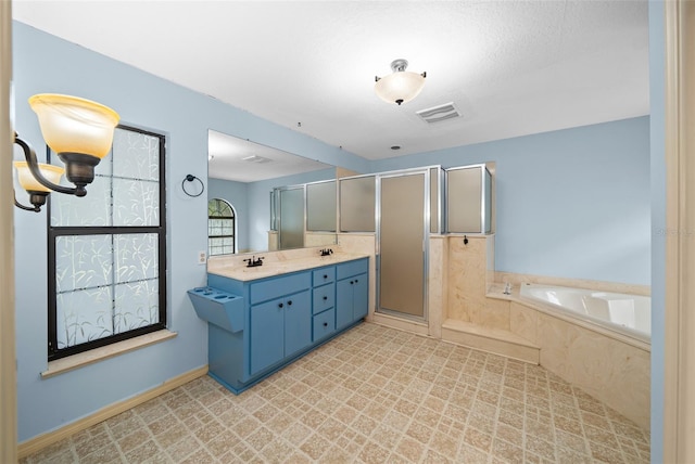 bathroom with vanity, separate shower and tub, and a textured ceiling