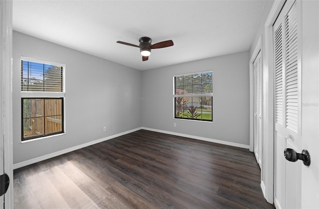 unfurnished bedroom featuring ceiling fan and dark hardwood / wood-style flooring