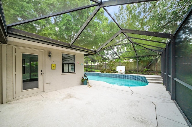 view of swimming pool with a patio and a lanai