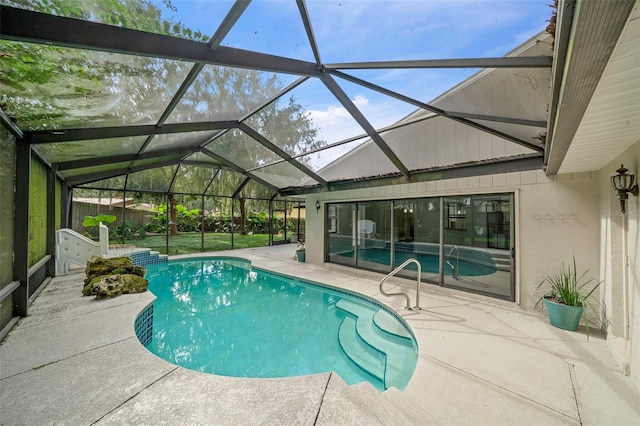 view of pool with a patio and a lanai