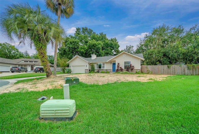 ranch-style home featuring a garage and a front lawn