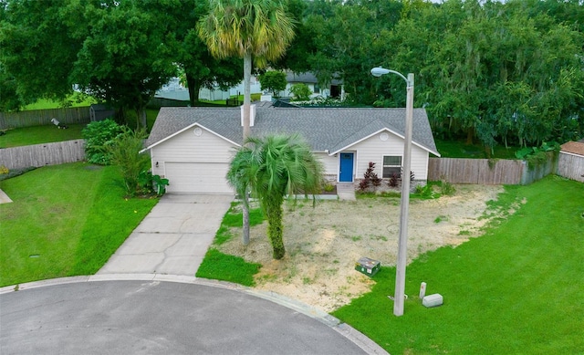 ranch-style house with a front yard and a garage