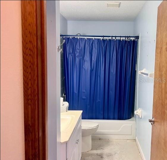 full bathroom featuring a textured ceiling, shower / bathtub combination with curtain, vanity, and toilet