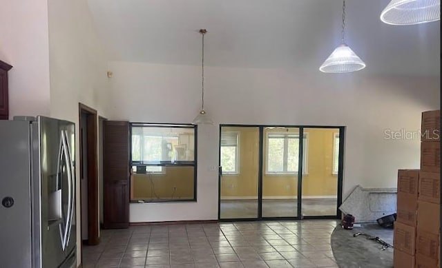 interior space featuring a towering ceiling and tile patterned floors