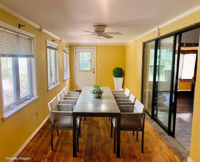 dining area with plenty of natural light, crown molding, and hardwood / wood-style flooring