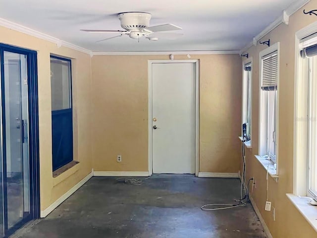 empty room featuring ornamental molding and ceiling fan