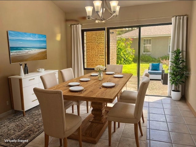 tiled dining area with a chandelier