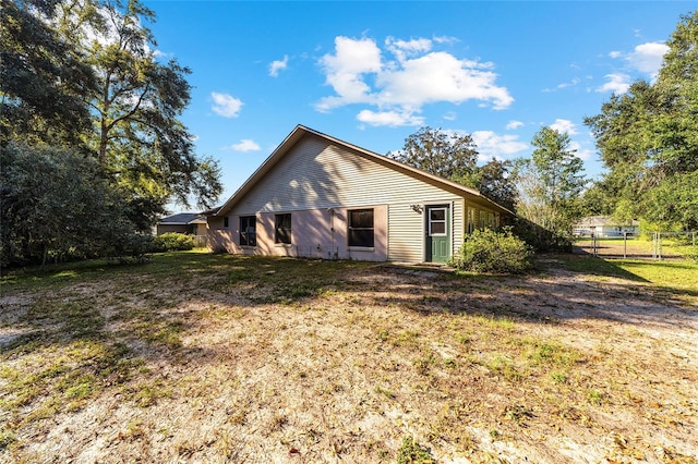 rear view of house with a yard