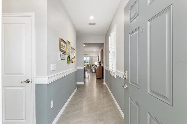 hall featuring light tile patterned floors