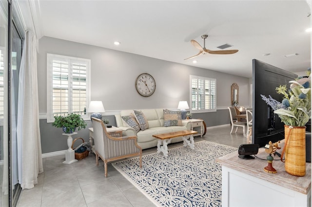 tiled living room featuring ceiling fan