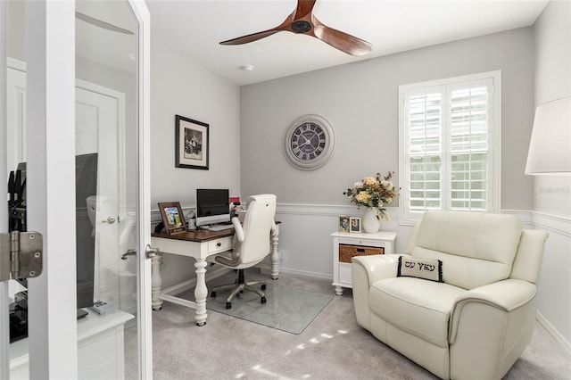 office space featuring light carpet and ceiling fan