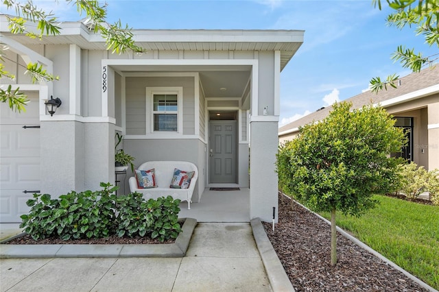 5089 Stokes Way, Wildwood, FL 34785 - property entrance with a garage and stucco siding