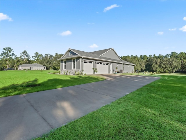 view of front of house with a front yard and a garage