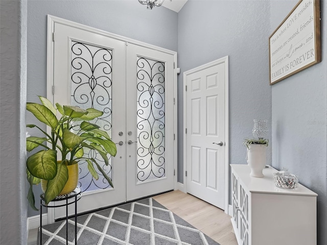 entrance foyer with french doors and light wood-type flooring