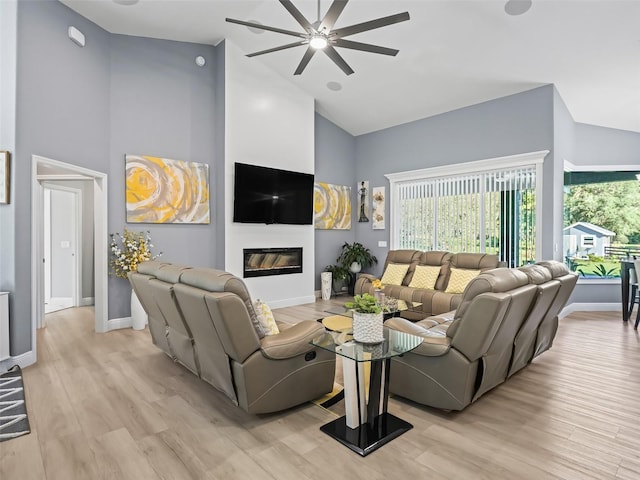 living room featuring ceiling fan, light wood-type flooring, and high vaulted ceiling