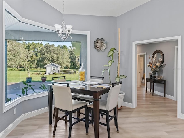 dining room with an inviting chandelier and light hardwood / wood-style flooring