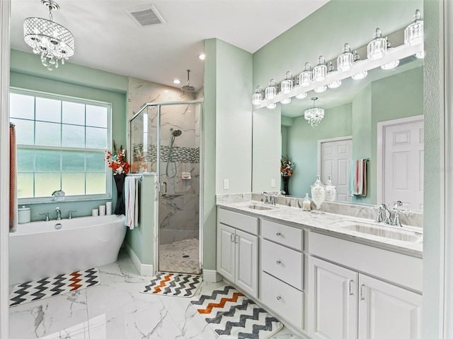 bathroom with a chandelier, shower with separate bathtub, and vanity