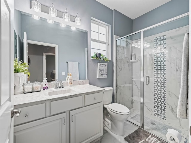 bathroom featuring vanity, an enclosed shower, and toilet