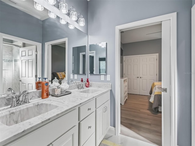 bathroom featuring a shower, hardwood / wood-style floors, and vanity