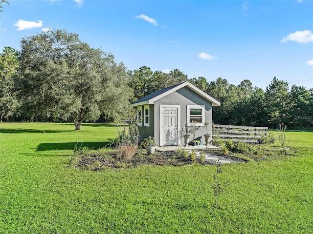 view of outbuilding with a yard