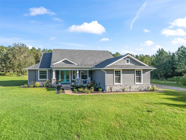 craftsman inspired home featuring a front lawn and covered porch