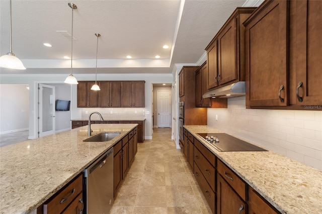 kitchen with pendant lighting, sink, light stone counters, decorative backsplash, and appliances with stainless steel finishes