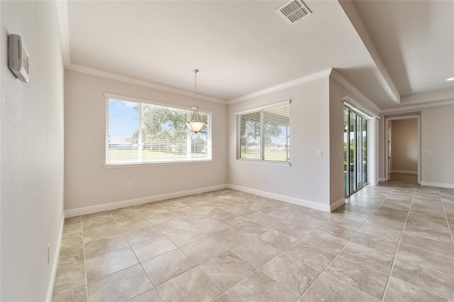 empty room with a notable chandelier, a textured ceiling, ornamental molding, and a wealth of natural light