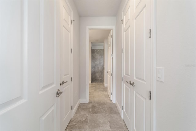 hall featuring light tile patterned floors