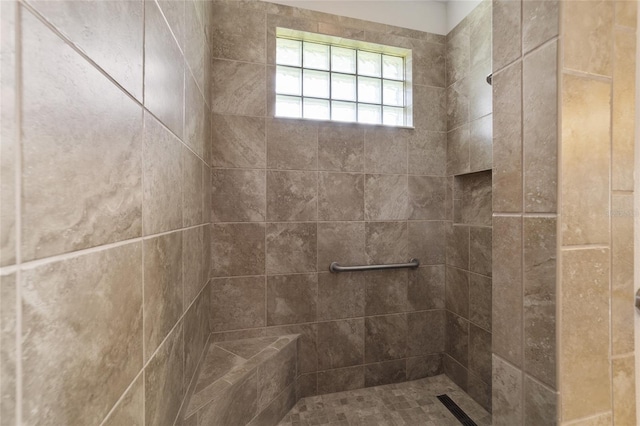 bathroom with a tile shower