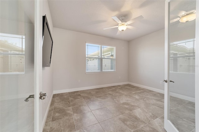 unfurnished bedroom with ceiling fan, light tile patterned flooring, french doors, and a textured ceiling