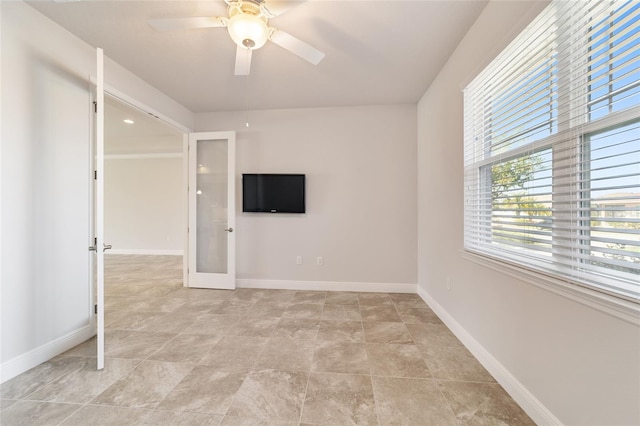 interior space with ceiling fan and french doors