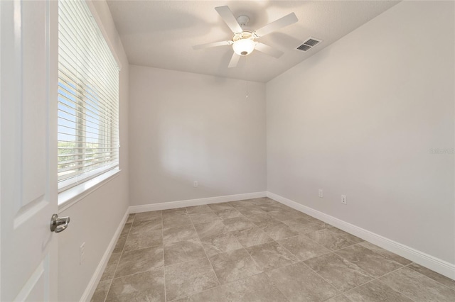 unfurnished room with light tile patterned flooring and ceiling fan