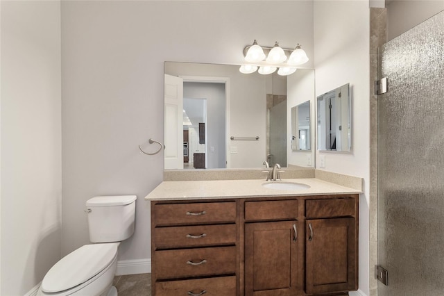 bathroom featuring an enclosed shower, vanity, and toilet