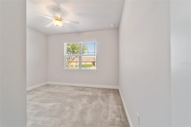 carpeted spare room with a textured ceiling and ceiling fan