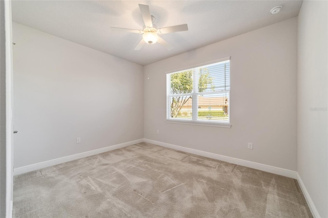 unfurnished room with ceiling fan and light colored carpet