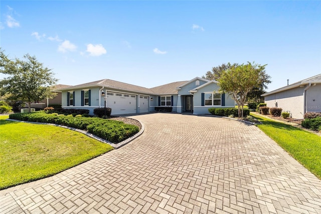 single story home with a front yard and a garage