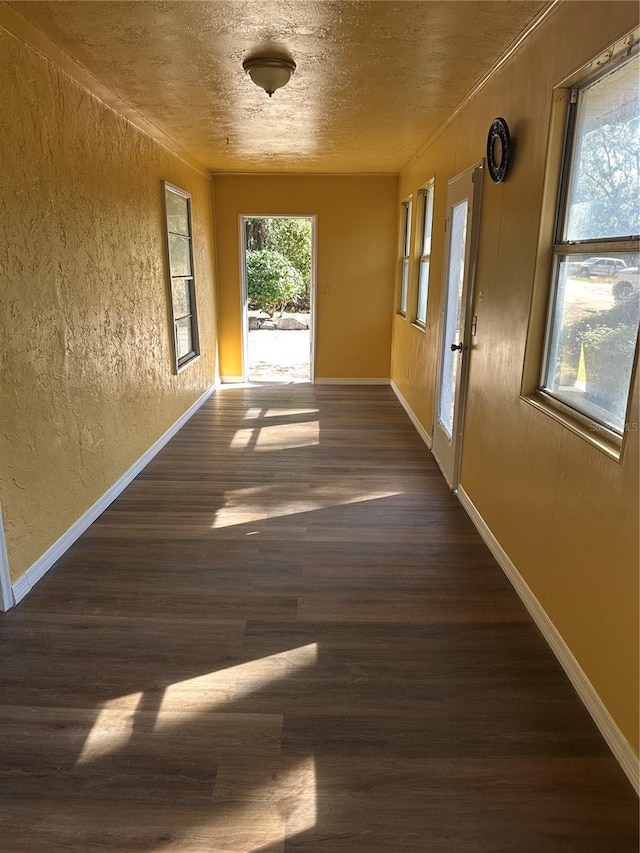 interior space with dark hardwood / wood-style flooring and a textured ceiling