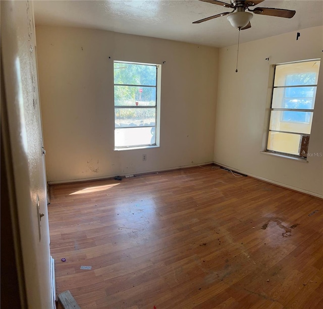 empty room featuring ceiling fan and wood-type flooring