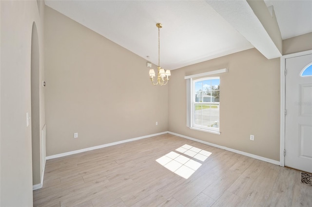 foyer entrance with an inviting chandelier and light hardwood / wood-style floors