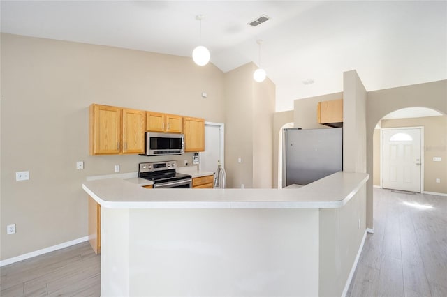 kitchen featuring light hardwood / wood-style floors, pendant lighting, kitchen peninsula, high vaulted ceiling, and appliances with stainless steel finishes