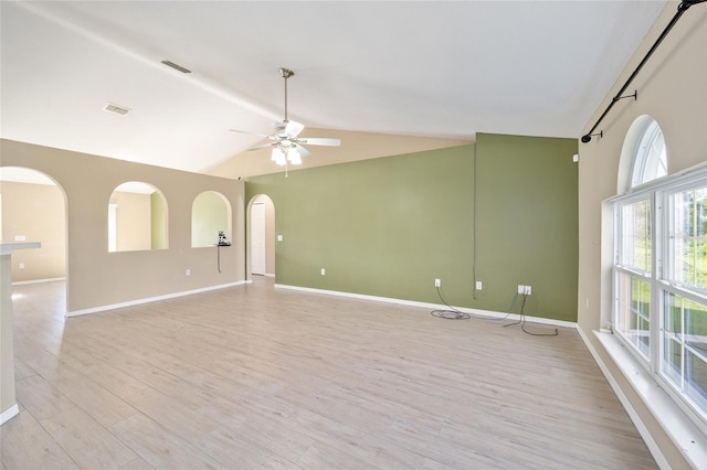 unfurnished room featuring ceiling fan, light wood-type flooring, and vaulted ceiling